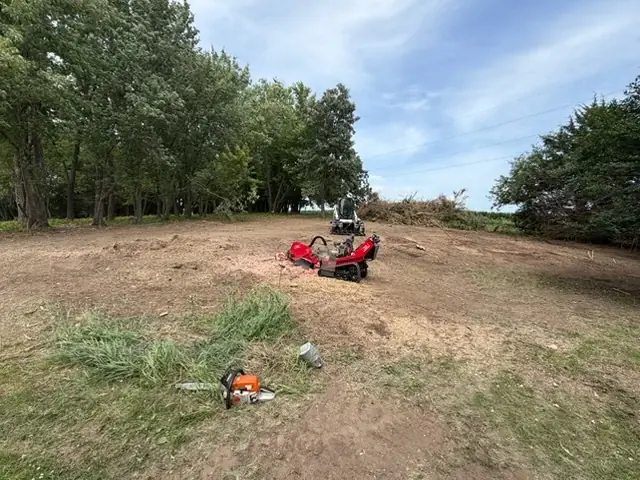 Stump grinder and equipment on a cleared property